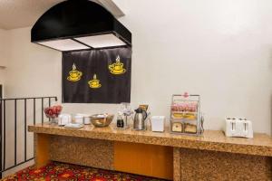 a counter in a hotel room with food on it at Quality Inn & Suites in Saint Louis