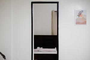 a mirror in front of a bed in a room at THE GRAY AURORA in Baguio