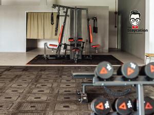a gym with some equipment in a room at Staycation Homestay 41 Liberty Grove Near Airport in Kuching