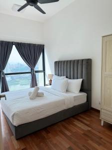 a bedroom with a large bed with a large window at Reizz Residence By Nexus Suites in Kuala Lumpur