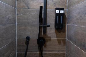 a tiled shower with two phones on the wall at Napoli Center Suite Palmentieri in Naples