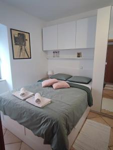 a bedroom with a bed with towels on it at City apartment Rina in Crikvenica