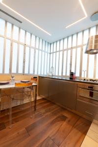 a large kitchen with a table and some windows at Omnia Domus in Turin