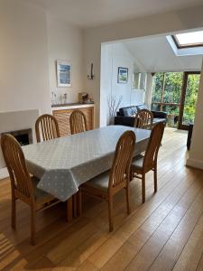 a dining room table and chairs in a living room at Peaceful Family Retreat Near Gloucester Road in Bristol