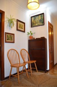 a room with two chairs and a table and a cabinet at Casa Aurora in Teo