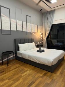a bedroom with a bed with a laptop on it at Reizz Residence By Nexus Suites in Kuala Lumpur