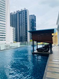 a swimming pool in a city with tall buildings at Reizz Residence By Nexus Suites in Kuala Lumpur