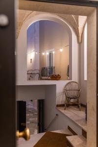 a view through a door into a room with a mirror at Palazzo Savino Southern Italian Lifestyle - Epoca Collection in Mesagne +95 photos