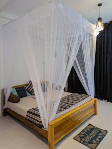 Een bed of bedden in een kamer bij Kai Kazee Ella