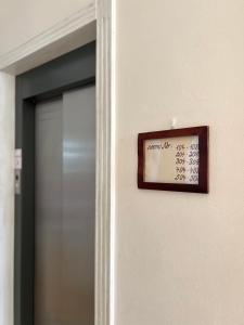ein Schild an einer Wand neben einer Tür in der Unterkunft Hotel GEO in Prag