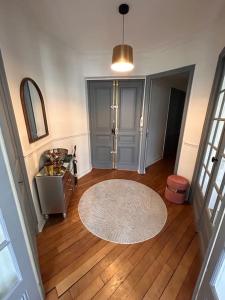 ein Wohnzimmer mit einem Teppich auf einem Holzboden in der Unterkunft * Le Cathédrale * in Reims