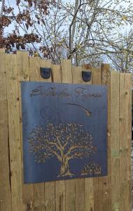 a sign on a wooden fence with a tree on it at Bulle des Fagnes in Philippeville