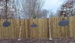 a wooden fence with three signs on it at Bulle des Fagnes in Philippeville +3 photos