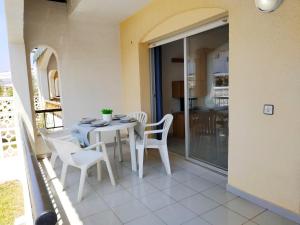 a table and chairs on the balcony of a house at Adosado Peñismar II Orangecosta in Peniscola