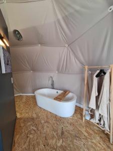 a bathroom with a tub in a tent at Bulle des Fagnes in Philippeville