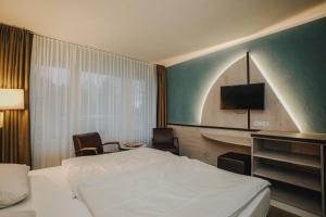 Un pat sau paturi într-o cameră la Hotel Spiekeroog