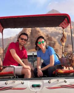 a man and a woman sitting in the back of a boat at Bedouin bunch camp in Wadi Rum