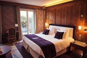 a hotel room with a large bed and a window at Relais Bernard Loiseau in Saulieu +77 photos