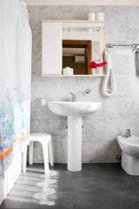 a bathroom with a white sink and a toilet at Locanda Montegrappa in Borso del Grappa