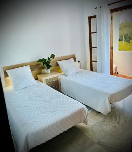 dos camas sentadas una al lado de la otra en un dormitorio en Mojacar Casa El Cantal Playa con vistas la Mar, en Mojácar