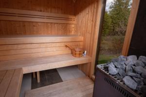 a sauna with a bench and a stove at A Mi Házunk in Gyenesdiás