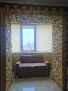 a couch in a room with two windows at Apartment on Kravchuka 11b in Lutsk