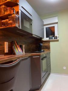 a kitchen with stainless steel appliances and a window at Nahe Airport BER/ Adlershof in Schönefeld