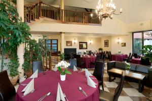 a dining room with a table with purple tablecloths at Hotel Jaśmin in Owińska