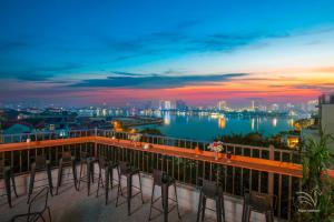 balcón con sillas y vistas al agua en Westlake Pearl Apartment & Hotel - By Pegasy Group en Hanoi