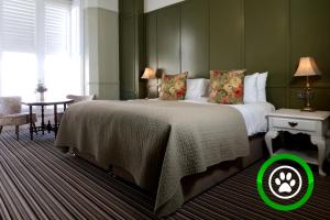 a bedroom with a large bed with a green circle around it at The Southern Belle in Brighton & Hove