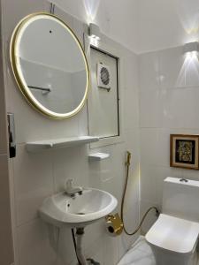 un bagno con lavandino, specchio e WC di كورنيش عجمان ad Ajman