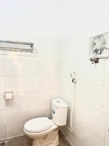 a bathroom with a toilet and a air conditioner at Huong Thao Hostel & Tours in Dien Bien Phu