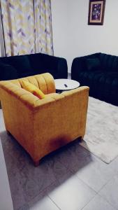 a yellow couch sitting in a living room at Bonyeza Safaris Staycations-Kenya in Ruiru