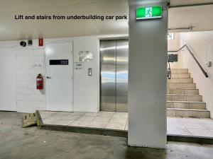 a building with a lift and stairs from underbuilding car park at Lighthouse Apartments on The Strand - Penthouse in Townsville