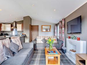 a living room with a couch and a table at 3 Bed in Banchory 94062 in Strachan