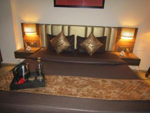 a bedroom with a large bed with a large headboard at Peaceful Stay in New Delhi