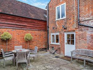 a patio with a table and chairs and a building at 3 Bed in Broughton 94143 in Broughton