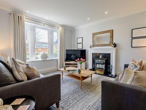 a living room with a couch and a fireplace at 3 Bed in Loweswater 94152 in Arlecdon