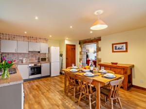 a kitchen and dining room with a wooden table at 3 Bed in Malham 94259 in Airton