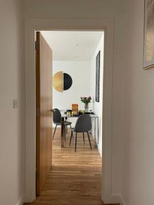 a hallway leading to a dining room with a table at Home from Home in Brompton