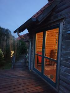 a cabin with a window and a deck at Traum im Grünen in Kittendorf