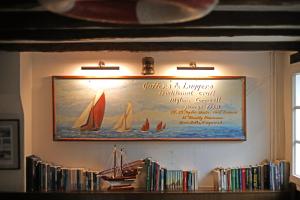 a framed picture of sail boats on a wall at THE CORNISH ARMS Guest House in Solingen