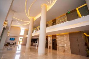 a lobby with two large columns in a building at Le Bosquet in Shaqra
