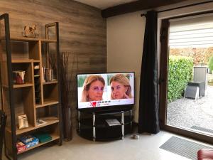 a flat screen tv sitting in a living room at Gîte La Gernelle in Bouillon