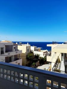 a view of the ocean from a balcony at Manolo Saxophone Apartment Rethymno in Rethymno Town