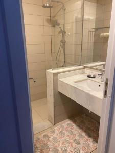 a bathroom with a sink and a shower with a mirror at Almaza Bay, 2 bd ground floor (Prime location) in Marsa Matruh
