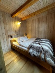 a bedroom with a bed in a wooden room at Sälen Moderna Lodge in Sälen