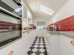 a kitchen with a black and white checkered floor at 4 Bed in Aberporth 93783 in Aberporth
