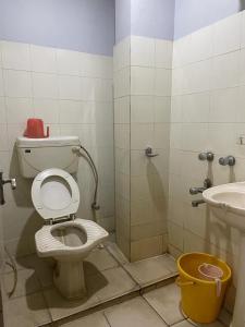a bathroom with a toilet and a sink at Starline Hotel in Agartala