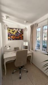 a desk with a mirror and a chair in a room at Lou Masadous : Magnifique villa tout confort avec piscine chauffée 11x3.5 in Montauroux